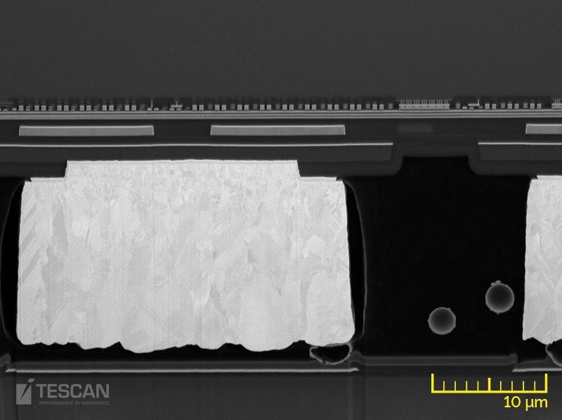 Cu bumps and metallization between thick Si and glass layers in a TFT panel (chụp bằng Kính hiển vi điện tử quét SEM và FIB-SEM TESCAN)